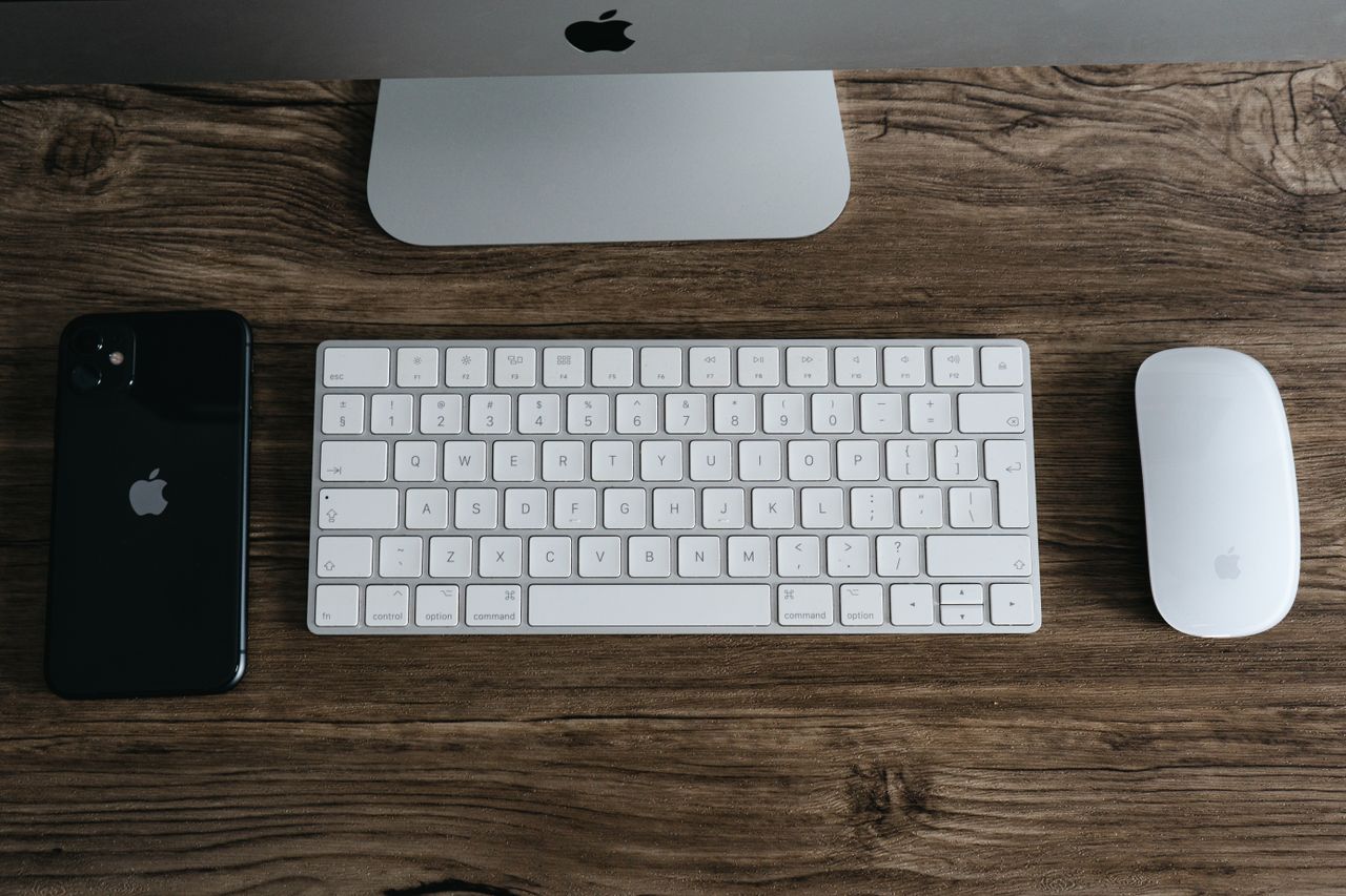 Mastering the First Impression: Your intriguing post title goes here A minimalist workspace featuring a smartphone, keyboard, and mouse on a wooden desk.